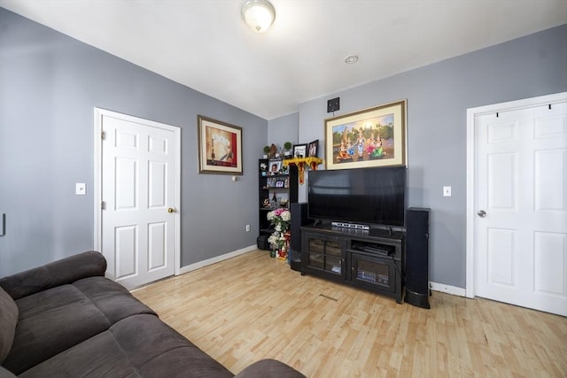 living room featuring wood finished floors and baseboards