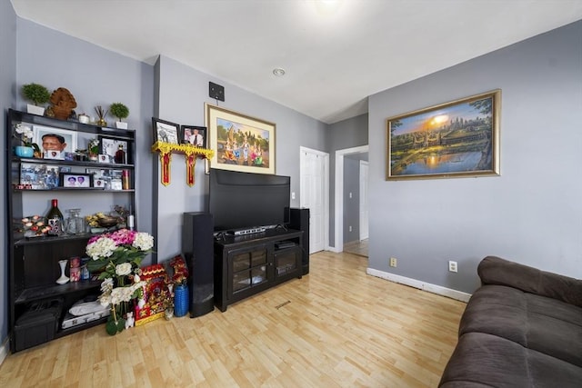 living area featuring wood finished floors and baseboards