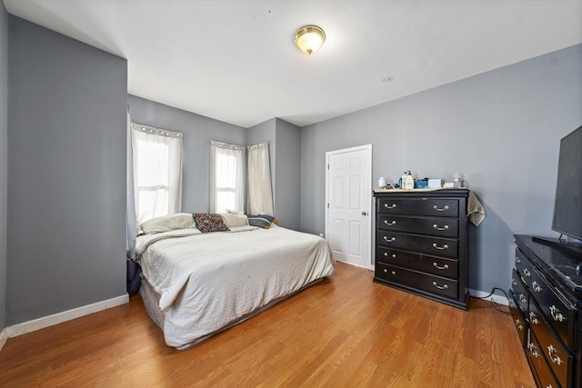 bedroom featuring wood finished floors and baseboards