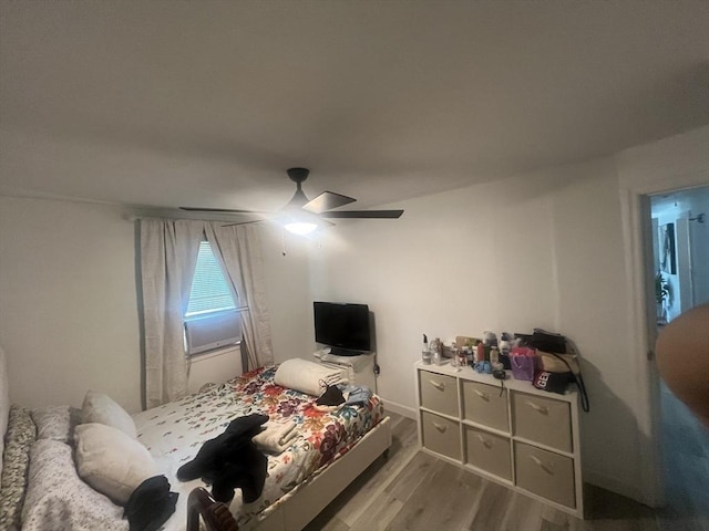 bedroom with ceiling fan and wood finished floors