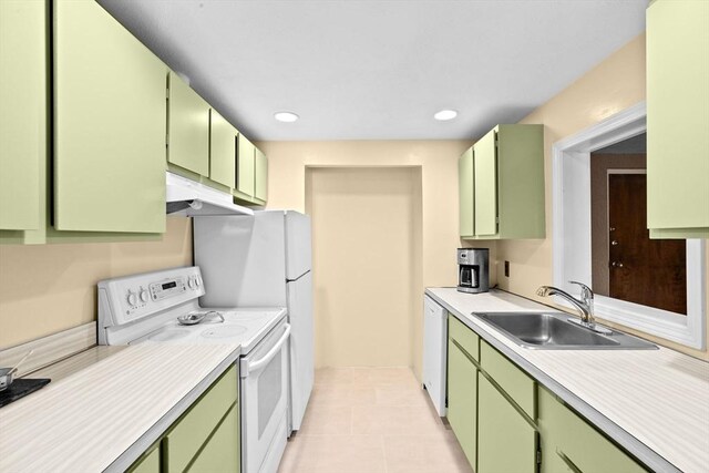 kitchen featuring a sink, light countertops, green cabinetry, under cabinet range hood, and white appliances