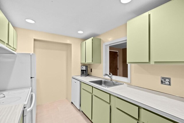 kitchen featuring white appliances, a sink, and green cabinets