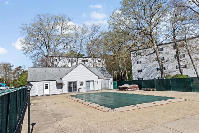 view of swimming pool featuring a patio, fence, and a fenced in pool