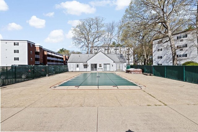 community pool featuring a patio and fence