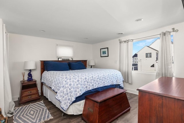 bedroom with baseboards and dark wood-style flooring