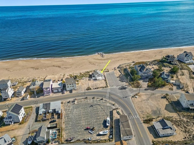 bird's eye view featuring a water view, a beach view, and a residential view
