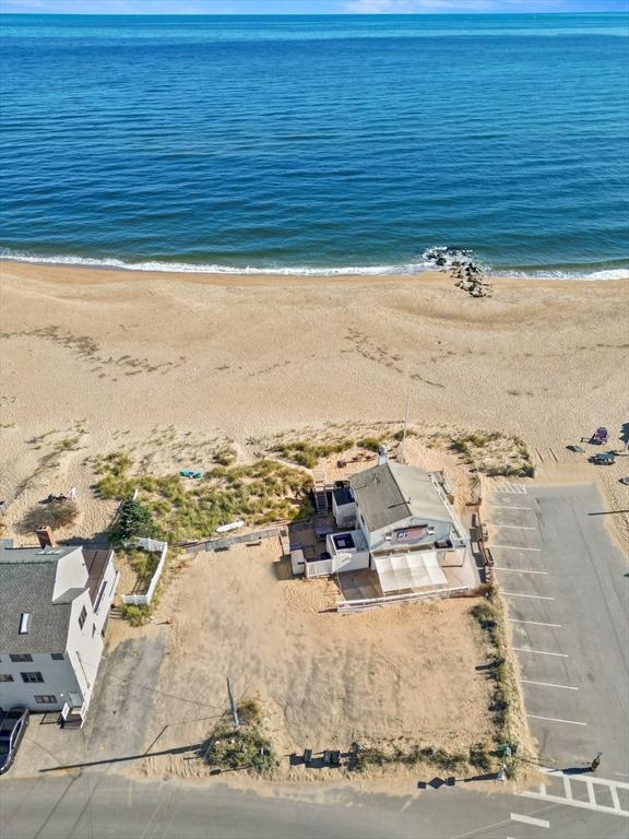 aerial view featuring a water view and a beach view