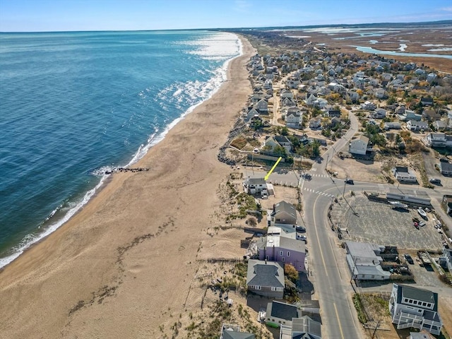 drone / aerial view featuring a water view and a view of the beach