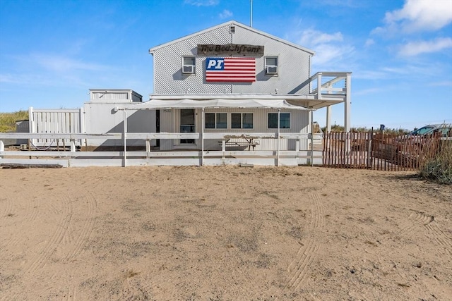 rear view of property featuring fence