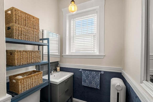 bathroom featuring radiator and vanity