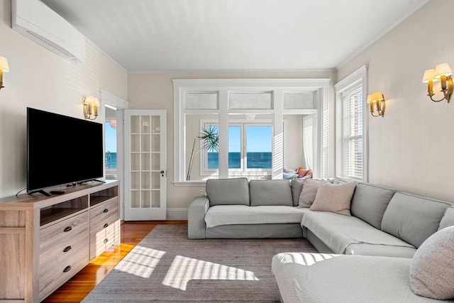 living room with a water view, an AC wall unit, ornamental molding, and hardwood / wood-style flooring