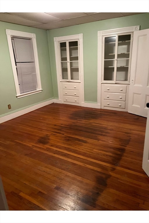 unfurnished bedroom with dark hardwood / wood-style floors