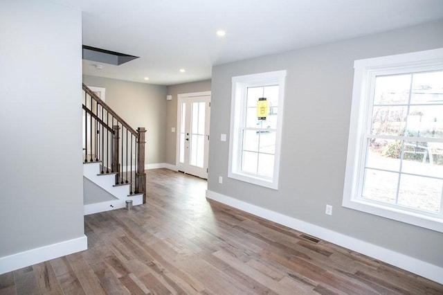 entryway featuring stairway, wood finished floors, baseboards, and recessed lighting