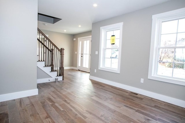entryway featuring stairs, recessed lighting, wood finished floors, and baseboards