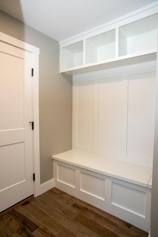mudroom featuring dark wood-style flooring and baseboards