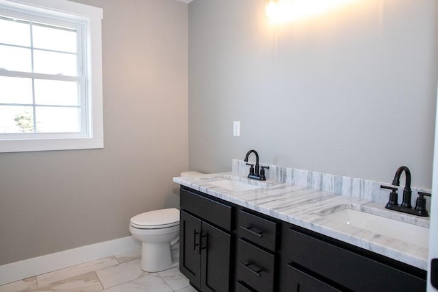 bathroom featuring baseboards, toilet, marble finish floors, and healthy amount of natural light