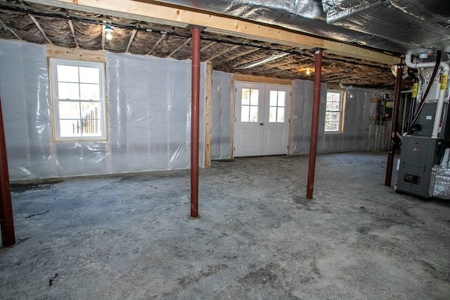 below grade area with heating unit and plenty of natural light