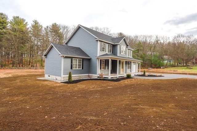 view of home's exterior with a porch and a shingled roof