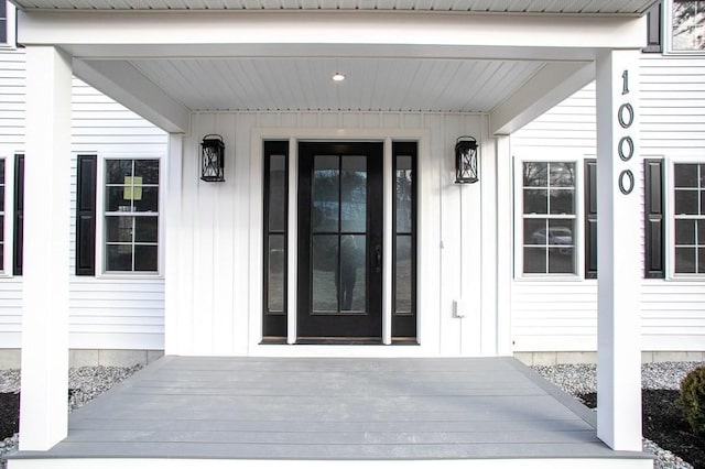 doorway to property featuring board and batten siding
