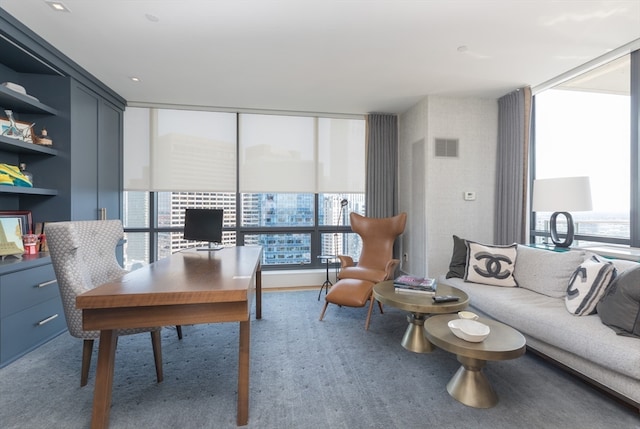 carpeted office featuring floor to ceiling windows