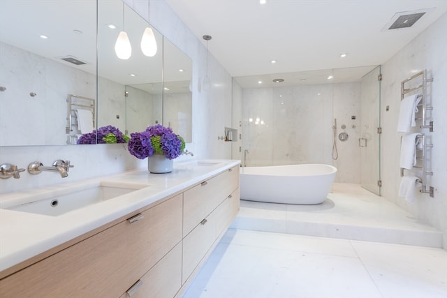 bathroom with shower with separate bathtub, vanity, tile walls, and tile patterned floors