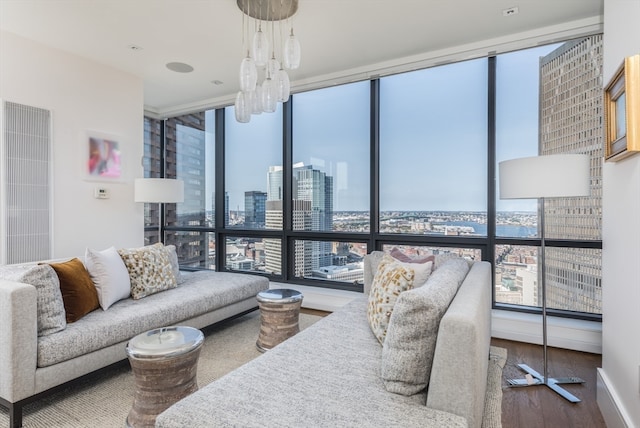 living room with plenty of natural light, expansive windows, and hardwood / wood-style flooring