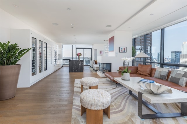 living room with hardwood / wood-style floors and expansive windows