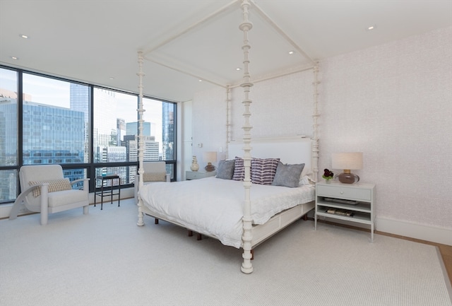 bedroom featuring hardwood / wood-style floors and expansive windows