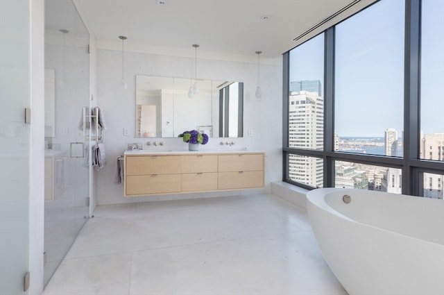 bathroom featuring shower with separate bathtub, concrete floors, and vanity