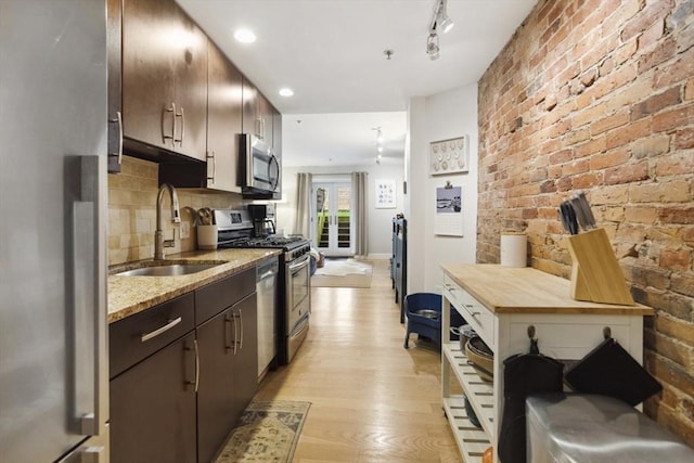 750 E 4th Unit 1, Boston, MA 02127 - kitchen with a sink, stainless steel appliances, light wood-style floors, dark brown cabinetry, and tasteful backsplash