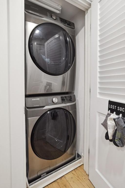 750 E 4th Unit 1, Boston, MA 02127 - laundry room featuring stacked washing machine and dryer and wood finished floors