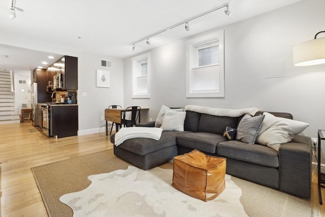 750 E 4th Unit 1, Boston, MA 02127 - living room with track lighting, light wood finished floors, recessed lighting, and baseboards
