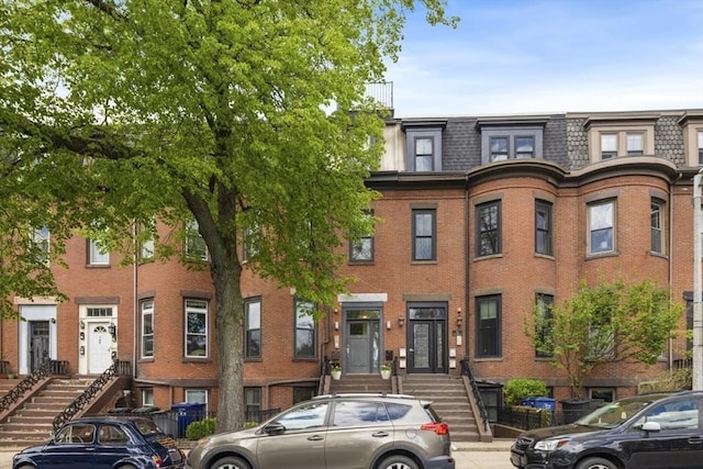 750 E 4th Unit 1, Boston, MA 02127 - view of property featuring brick siding, mansard roof, and stairway