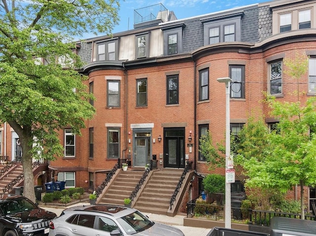 750 E 4th Unit 1, Boston, MA 02127 - view of property with mansard roof, brick siding, and stairs