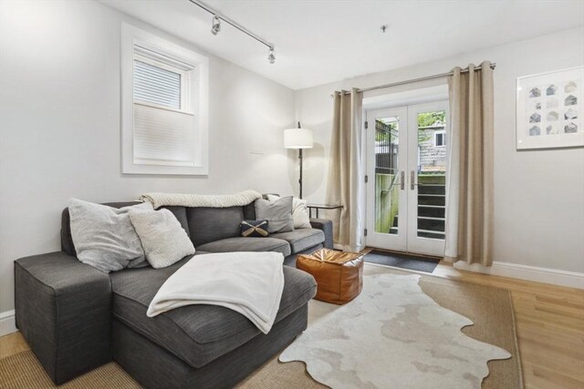 750 E 4th Unit 1, Boston, MA 02127 - living area with wood finished floors, rail lighting, baseboards, and french doors