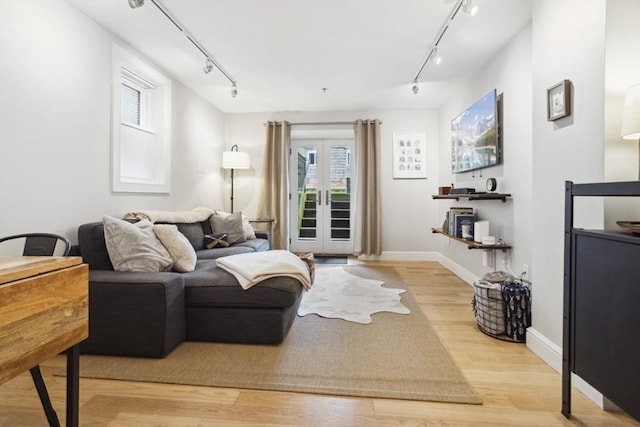 750 E 4th Unit 1, Boston, MA 02127 - living room featuring track lighting, wood finished floors, french doors, and baseboards