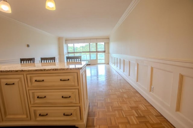 111 Perkins St Unit 42, Boston, MA 02130 - kitchen with crown molding, light stone counters, and a decorative wall