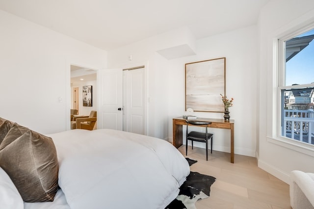 bedroom featuring light hardwood / wood-style floors and a closet