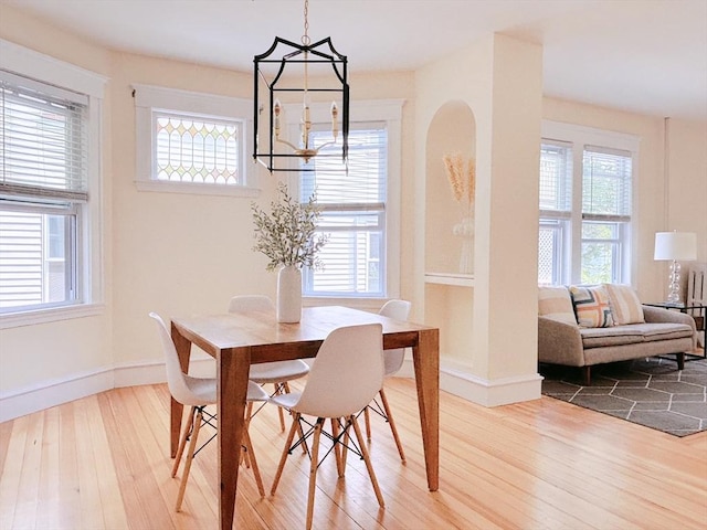 8 Fainwood Cir Unit 2, Cambridge, MA 02139 - dining room featuring a chandelier, wood finished floors, and healthy amount of natural light