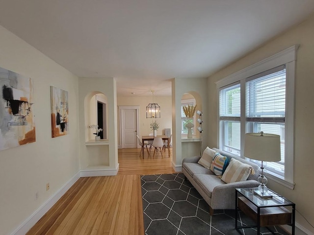 8 Fainwood Cir Unit 2, Cambridge, MA 02139 - living room featuring light wood finished floors, a chandelier, and arched walkways