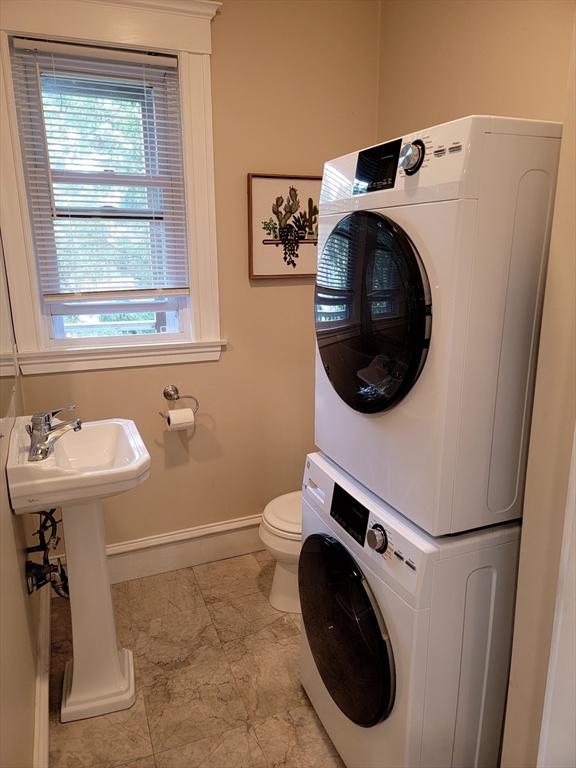 8 Fainwood Cir Unit 2, Cambridge, MA 02139 - half bathroom featuring estacked washer and dryer and baseboards