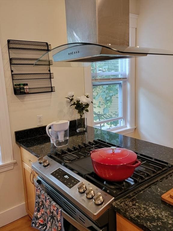 8 Fainwood Cir Unit 2, Cambridge, MA 02139 - kitchen with stainless steel gas stove, range hood, dark stone countertops, and light wood-style floors