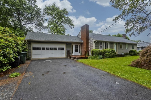 118 Woodland Rd, Springfield, MA 01129 - single story home featuring a chimney, a garage, asphalt driveway, and a front yard