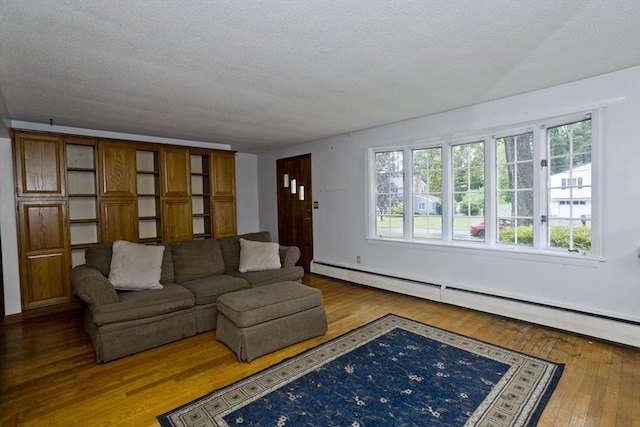 118 Woodland Rd, Springfield, MA 01129 - living room with hardwood / wood-style flooring, a textured ceiling, and a baseboard heating unit