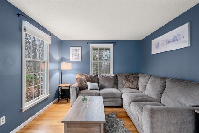 living room featuring light wood-style flooring and baseboards