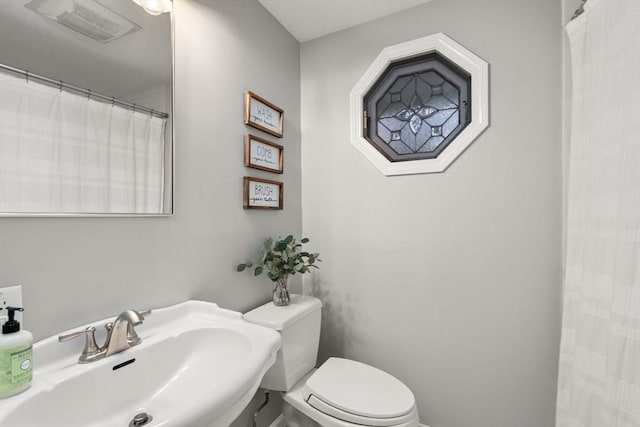full bathroom with visible vents, toilet, and a sink