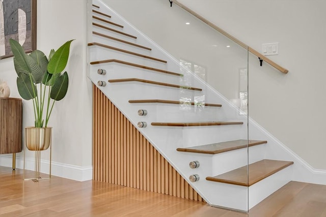 staircase featuring wood finished floors