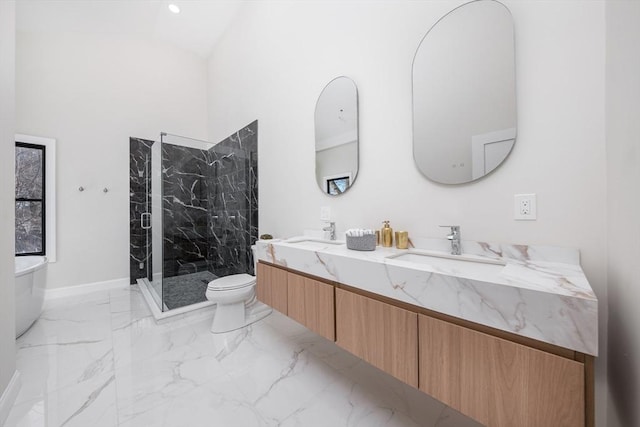 bathroom with marble tiled flooring, a marble finish shower, double vanity, toilet, and vaulted ceiling