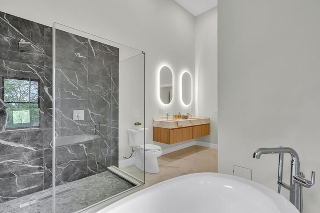 full bath with marble finish floors, a marble finish shower, toilet, a freestanding bath, and vanity