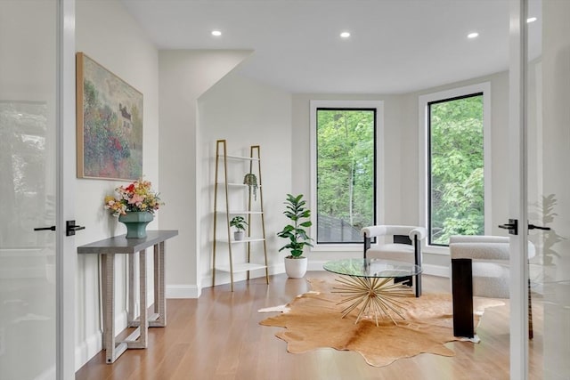 living area featuring wood finished floors, recessed lighting, and baseboards